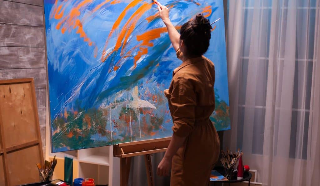 Modern artwork paint on canvas, fine art artist finishing her masterpiece