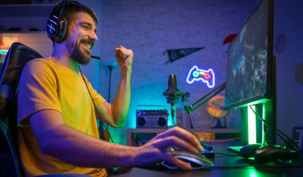 Professional Gamer winning and celebrating victory on his home computer game station