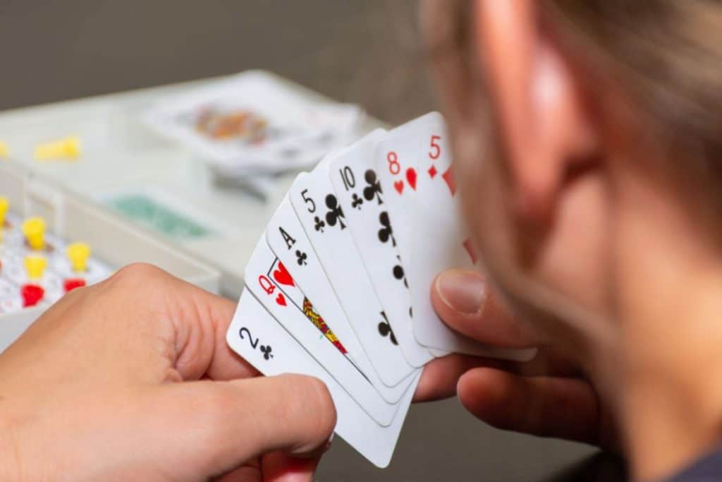 a girl holding a deck of cards