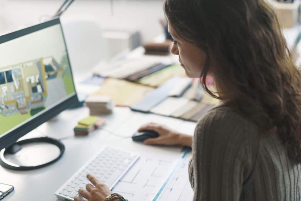 an interior designer working on a project on her computer