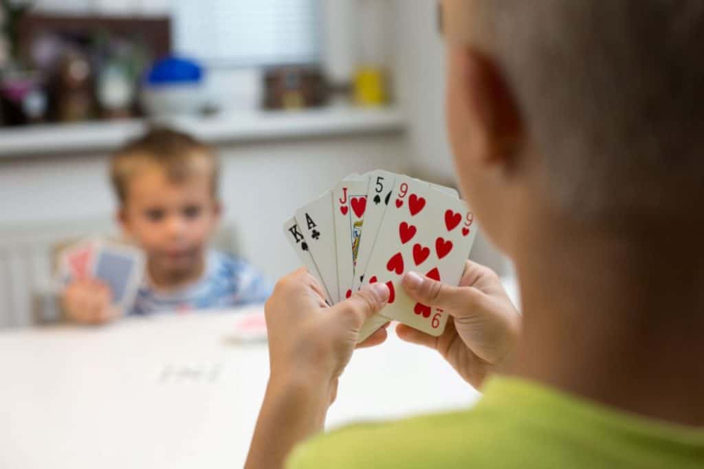 brothers playing cards in the dining area