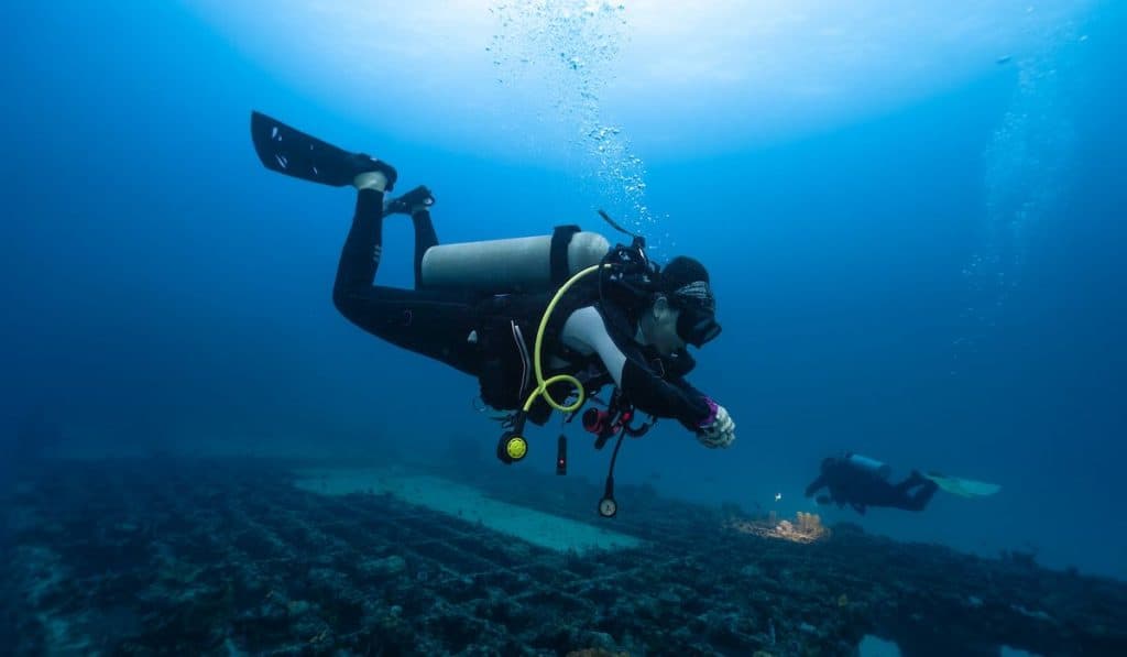 female diver practicing deep diving skills
