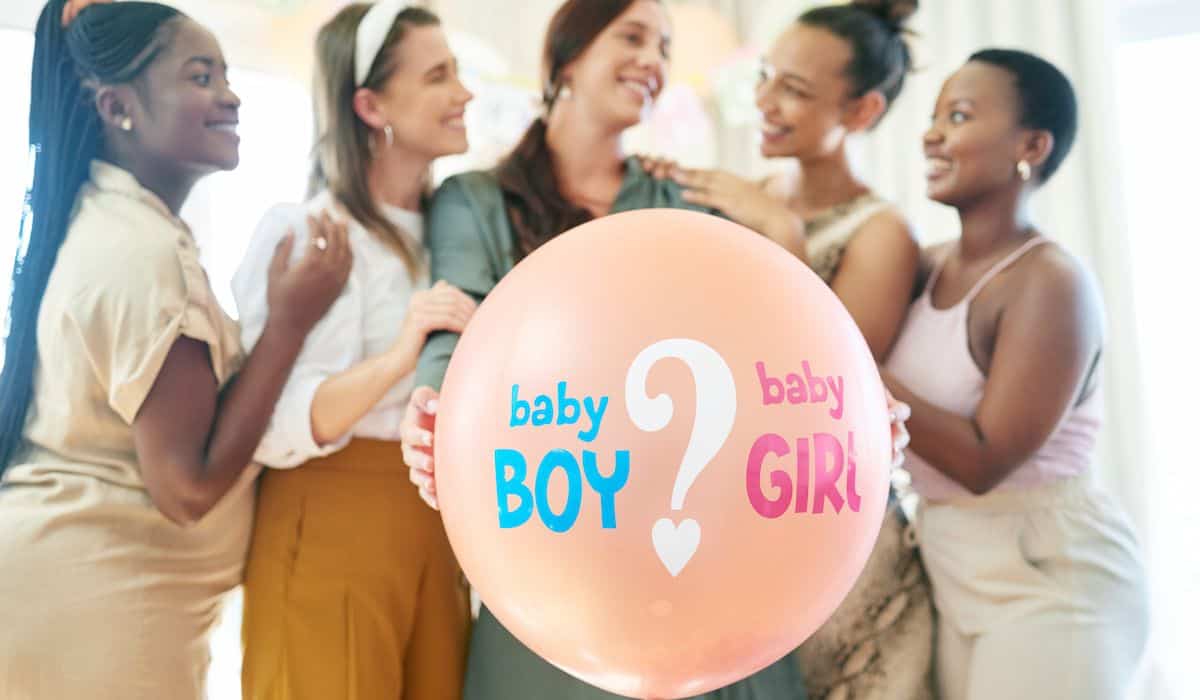 mom to be ready to pop the balloon to know the gender of her baby at her baby shower