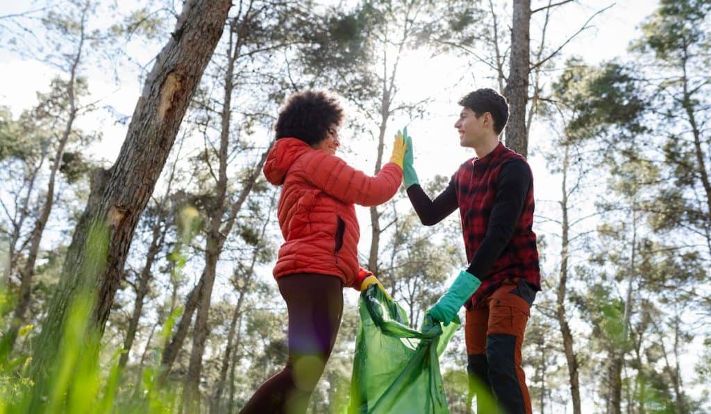 multiracial volunteers collect garbage in the forest
