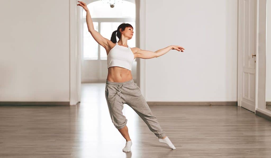 modern dance teacher rehearses the steps in the school by dancing elegantly