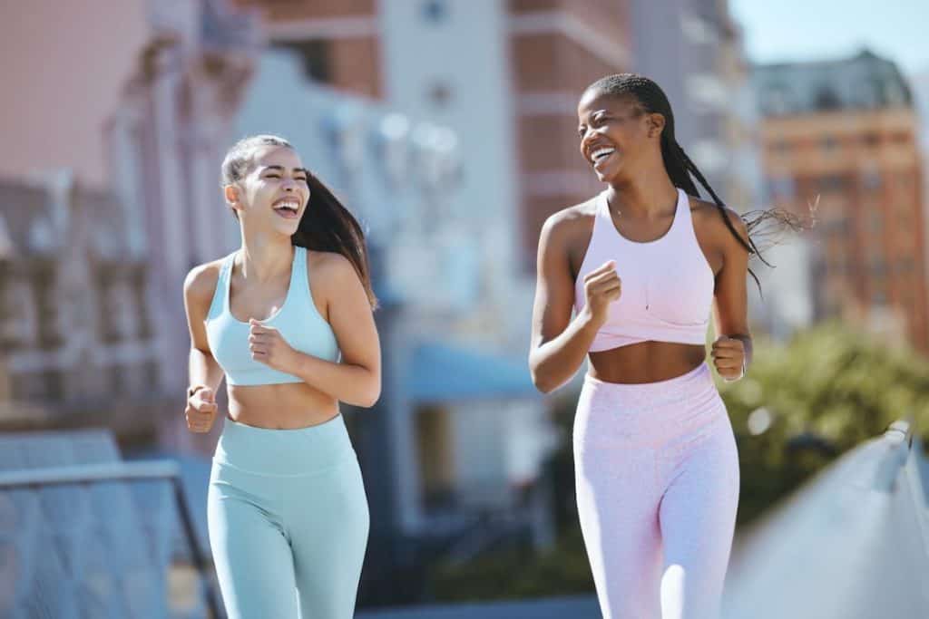 two young woman jogging outdoors