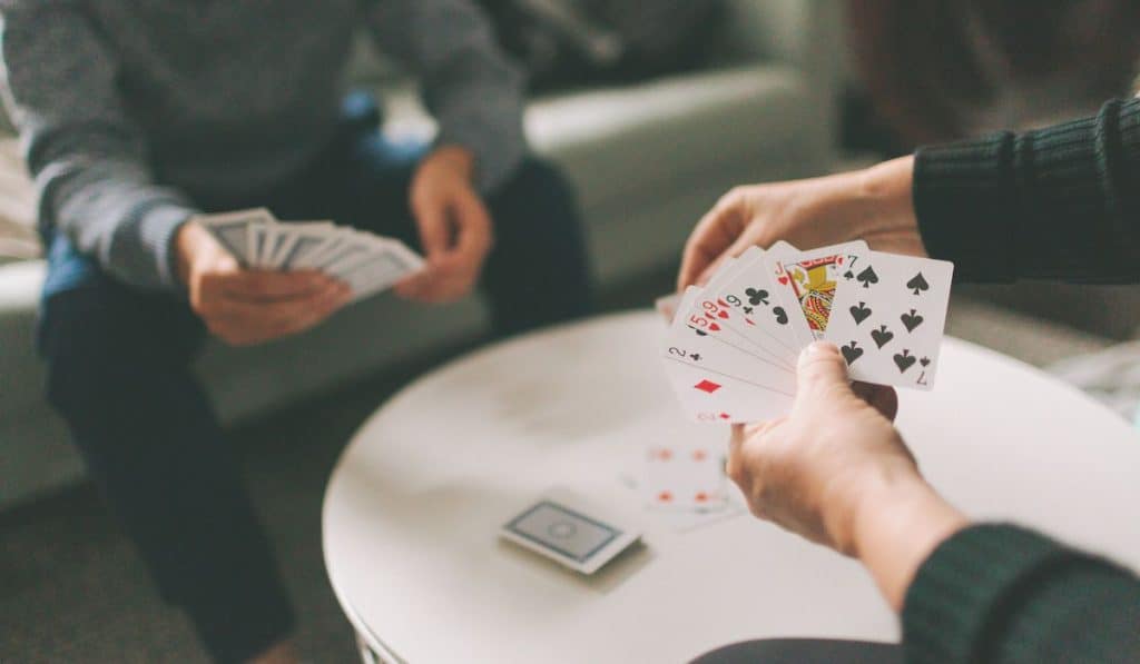 A couple playing cards indoors