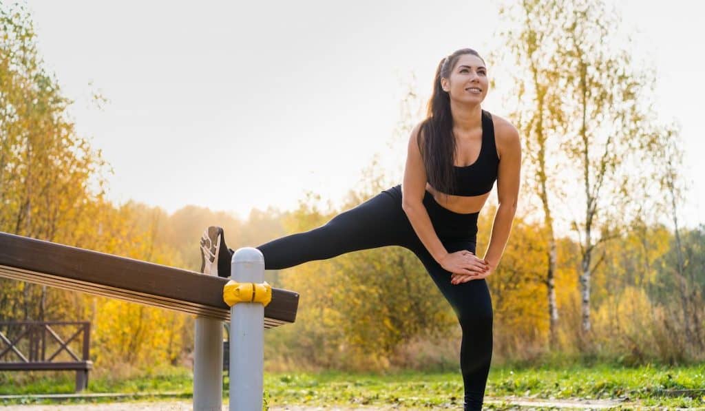 A young sportswoman trains outdoors in the park in autumn, healthy lifestyle