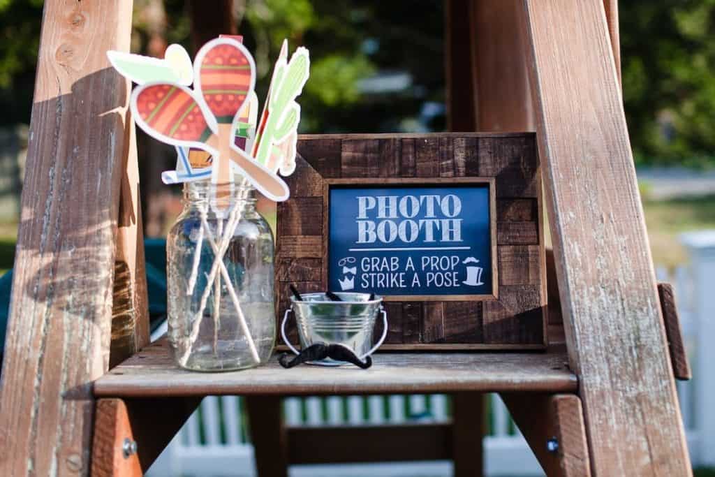 DIY photobooth set up in a garden with props available