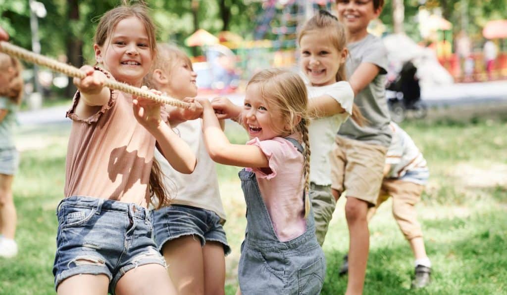 Group of kids playing tug of war
