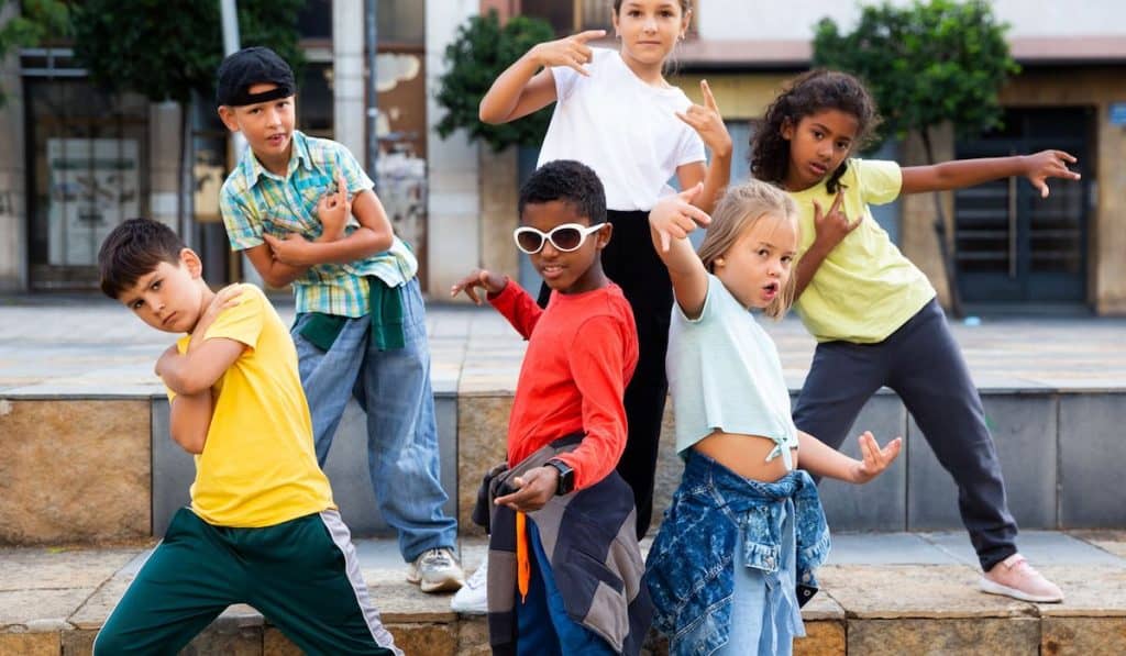 Kids dancing hip hop on the street, playing Freeze Dance