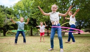 kids playing with hula hoop in park