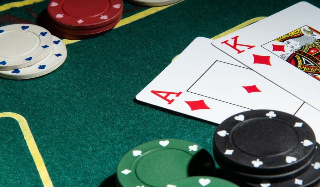 Poker cards on a playing green table with chips