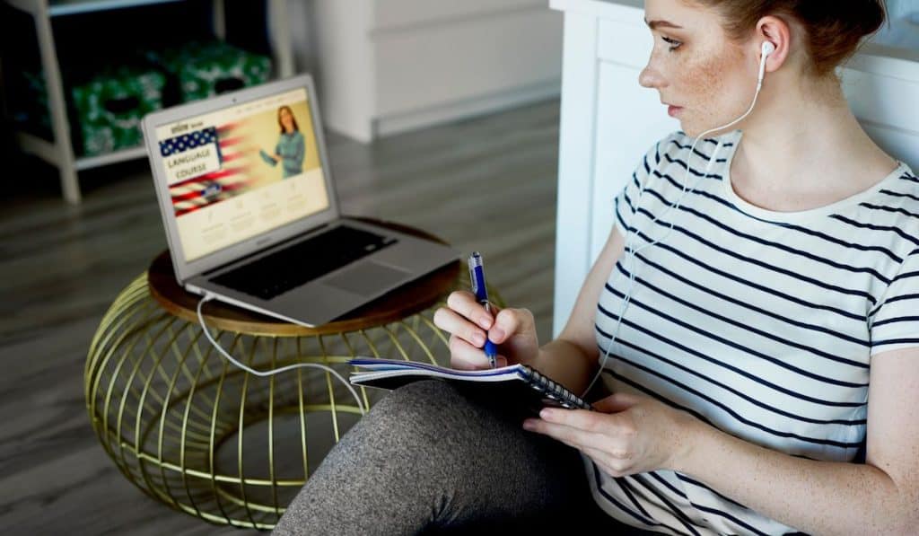 Young woman taking some language lesson online

