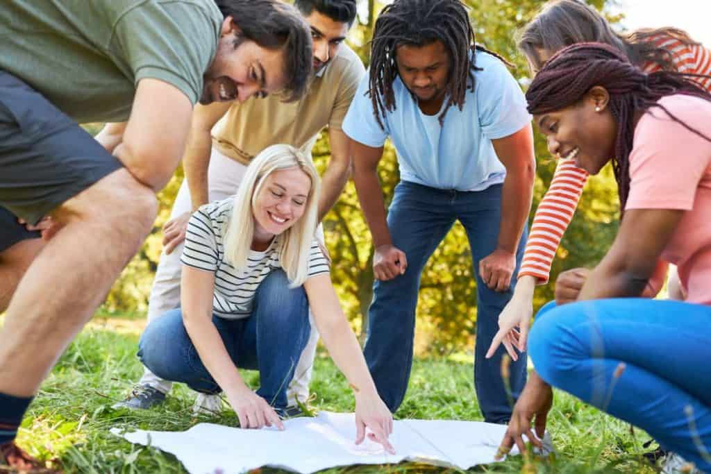 a group of friends outdoors playing scavenger hunt