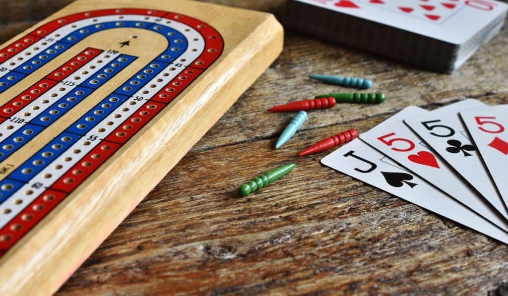 cribbage game card and board on wooden table 