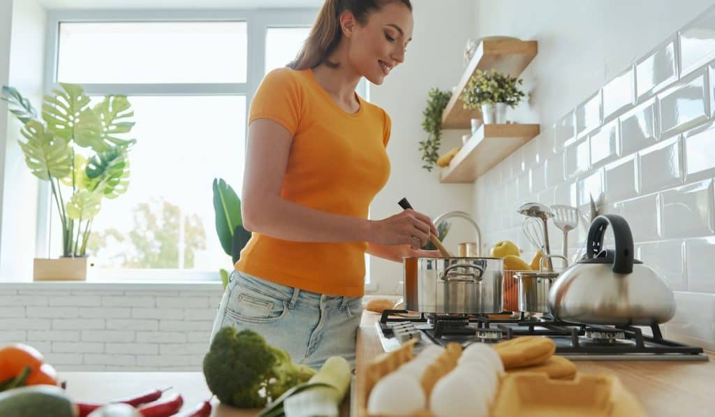 young woman cooking at the domestic kitchen