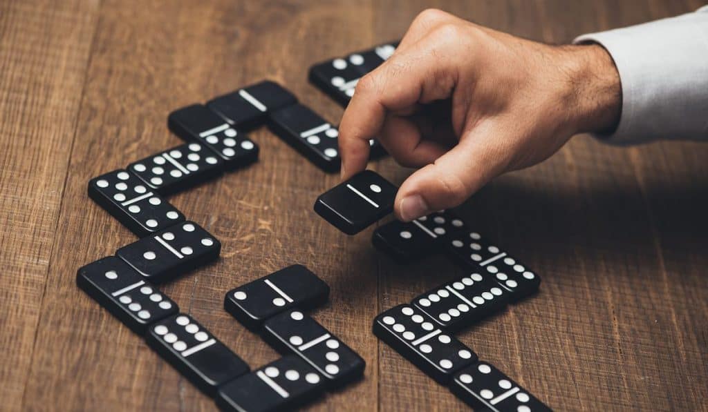 Businessman playing with dominoes
