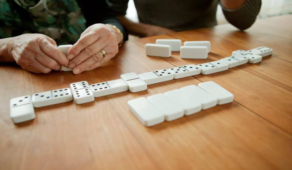 Mother and adult daughter playing dominoes
