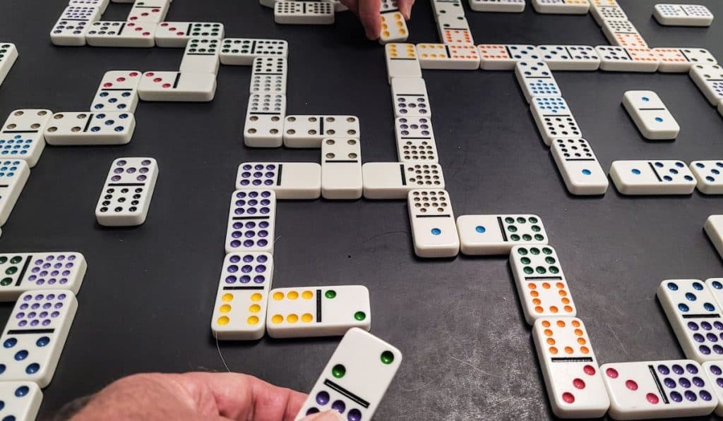 Playing the game of dominoes strategically on a black construction paper