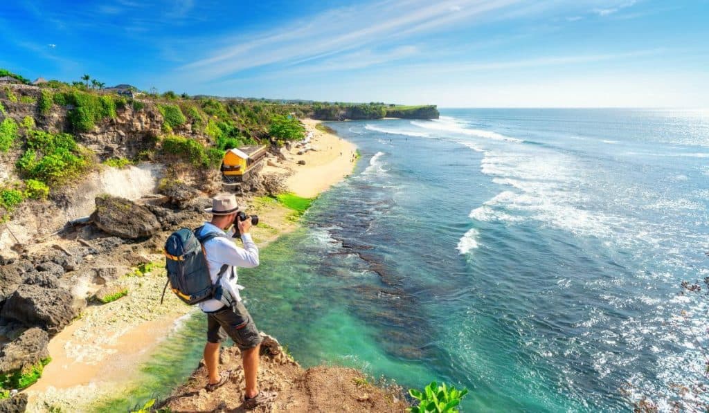 Man photographer with big backpack and camera