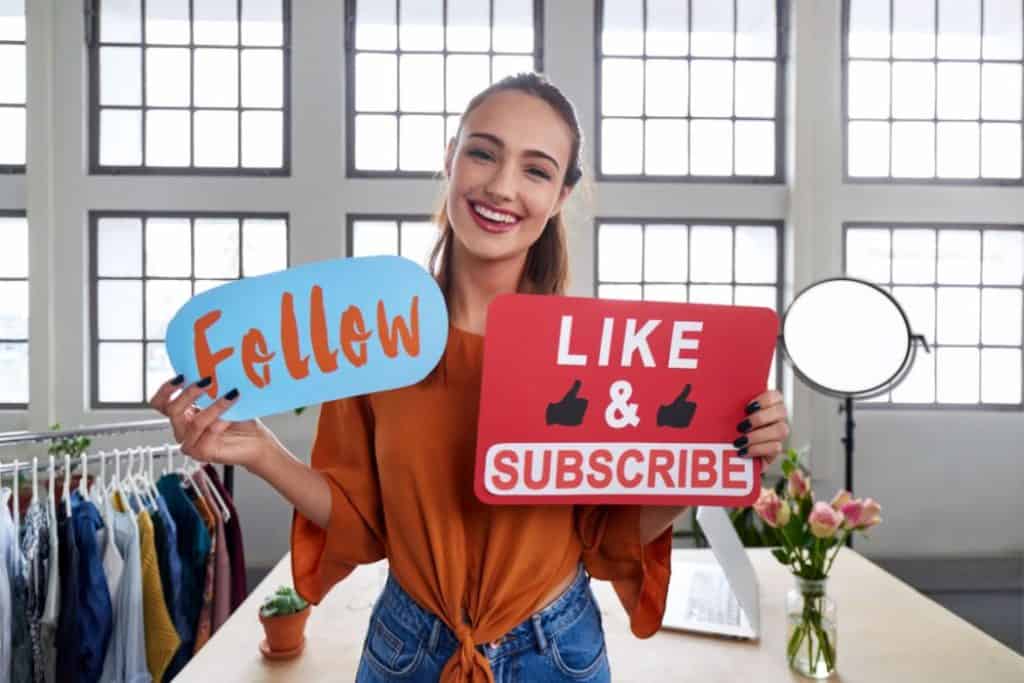 a female content creator holding a follow and like banner