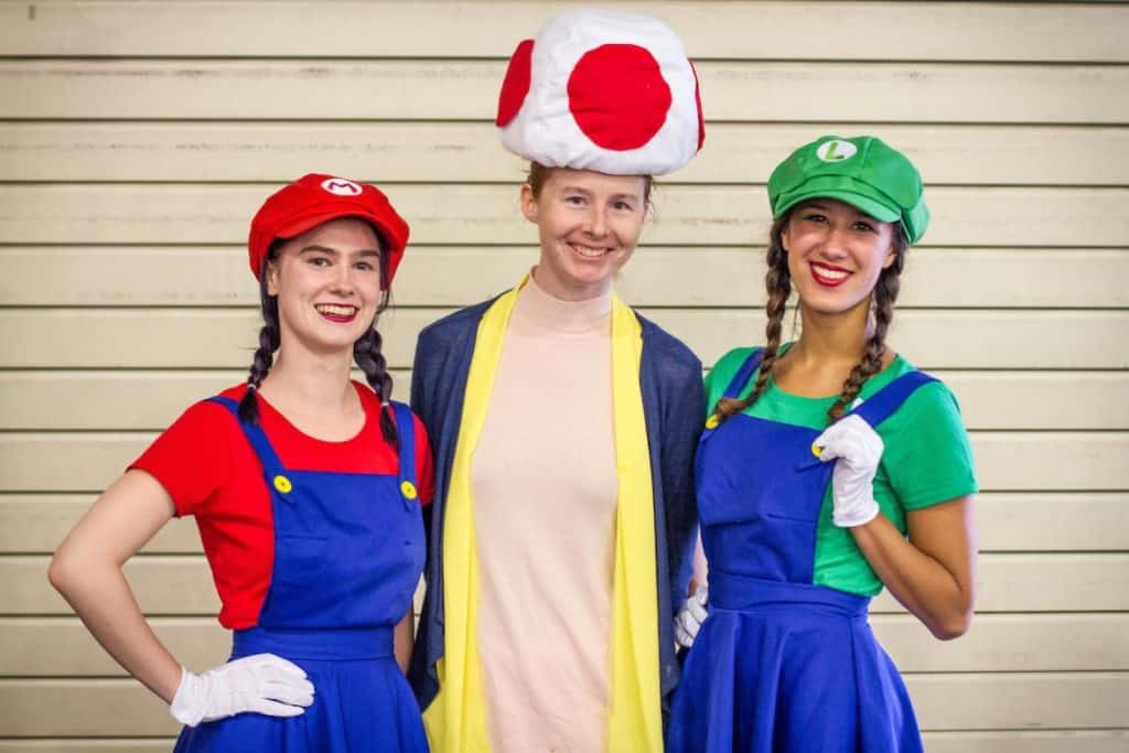  Three cosplayers dressed as the Super Mario Brothers Mario and Luigi with a Mushroom friend