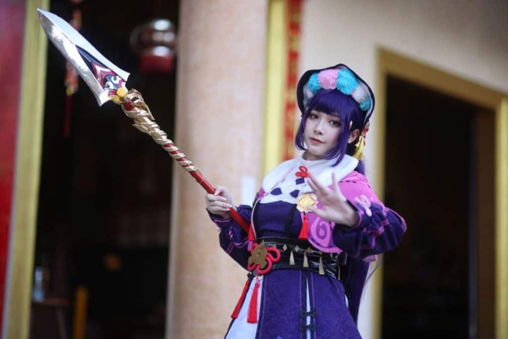 a girl wearing a violet wig hair holding a long spear 