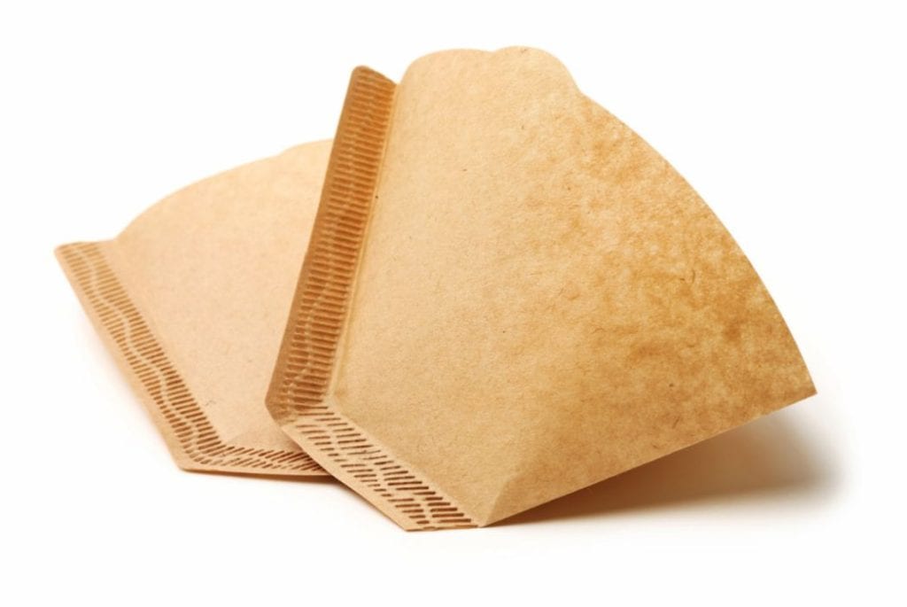 two brown coffee filter on white background