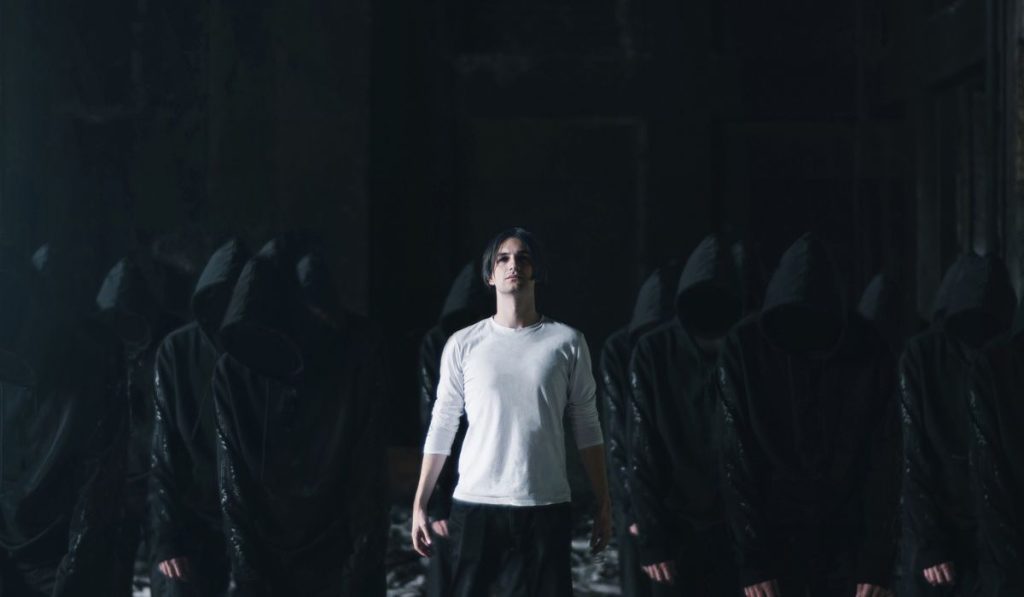 man in white with followers in black cult concept
