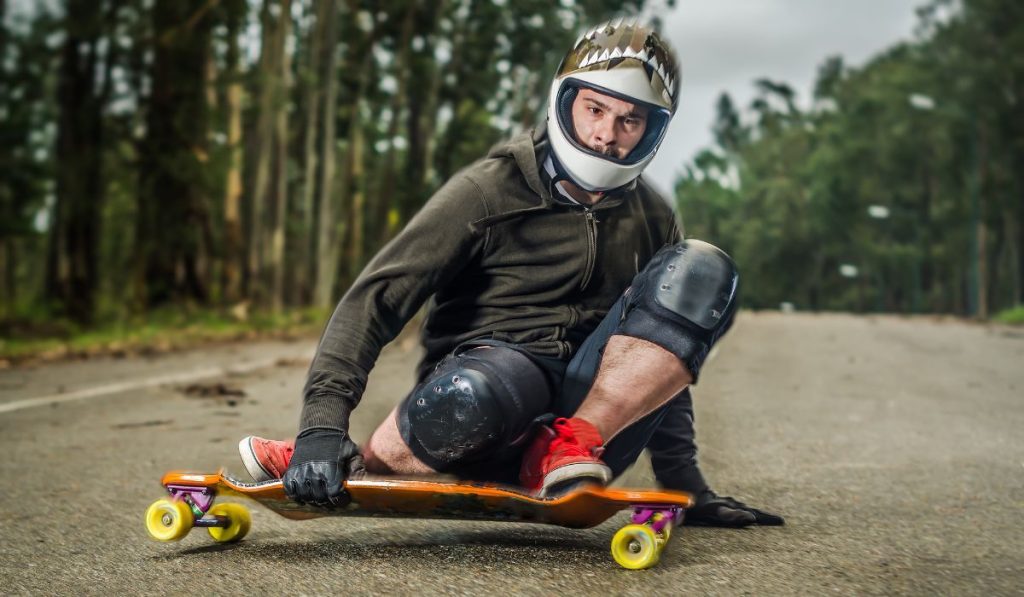 Downhill skateboarder in action on a asphalt road.
