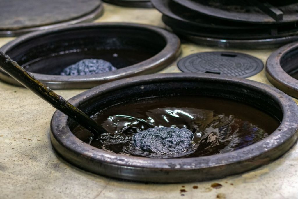 Japanese traditional indigo dyeing using big stir and pots 