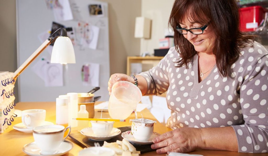Mature Woman Making Candles At Home
