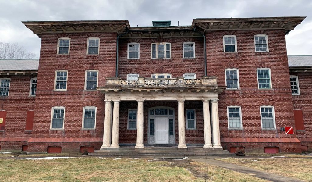 An abandoned building on the campus of the shuttered Medfield State Hospital