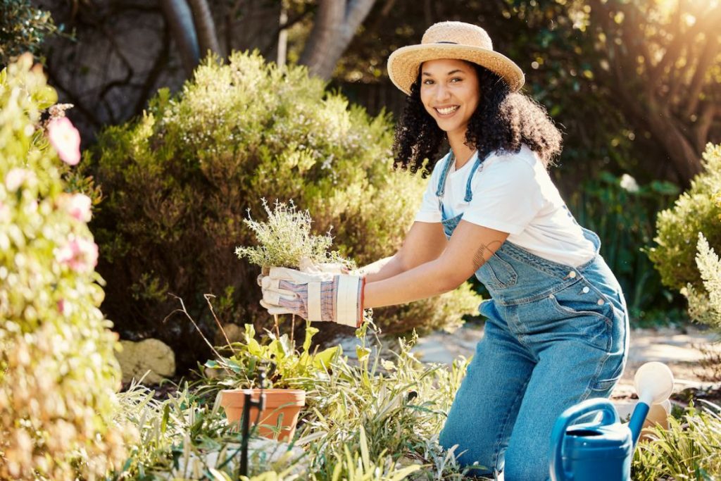 Woman, portrait and planting for backyard gardening with with smile