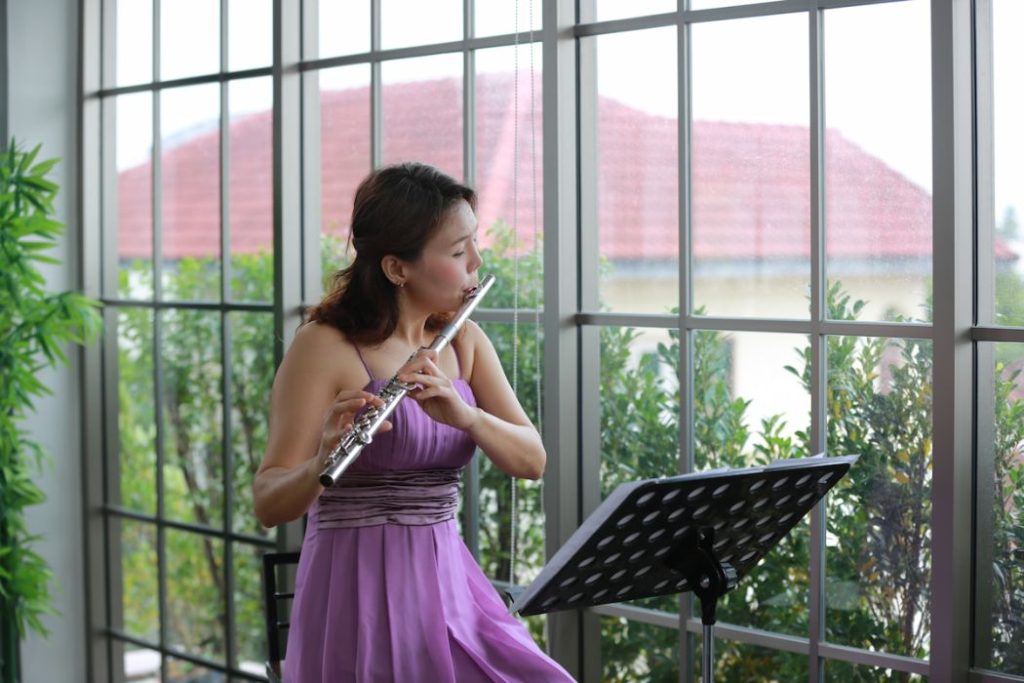 woman musician playing classical flute music instrument