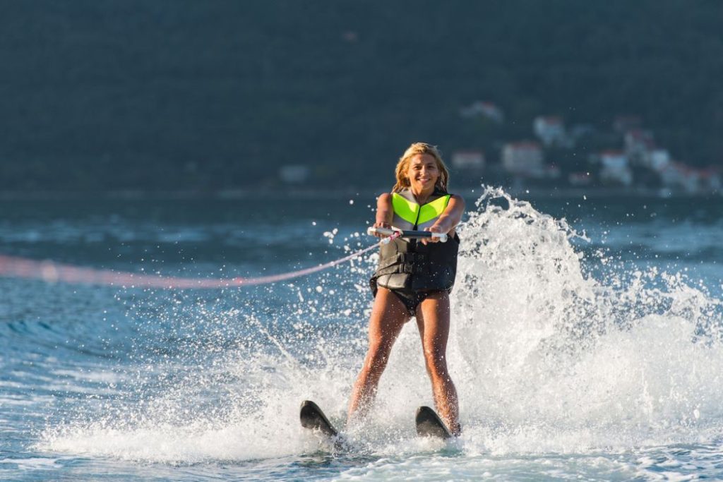 young woman water skiing on a sea
