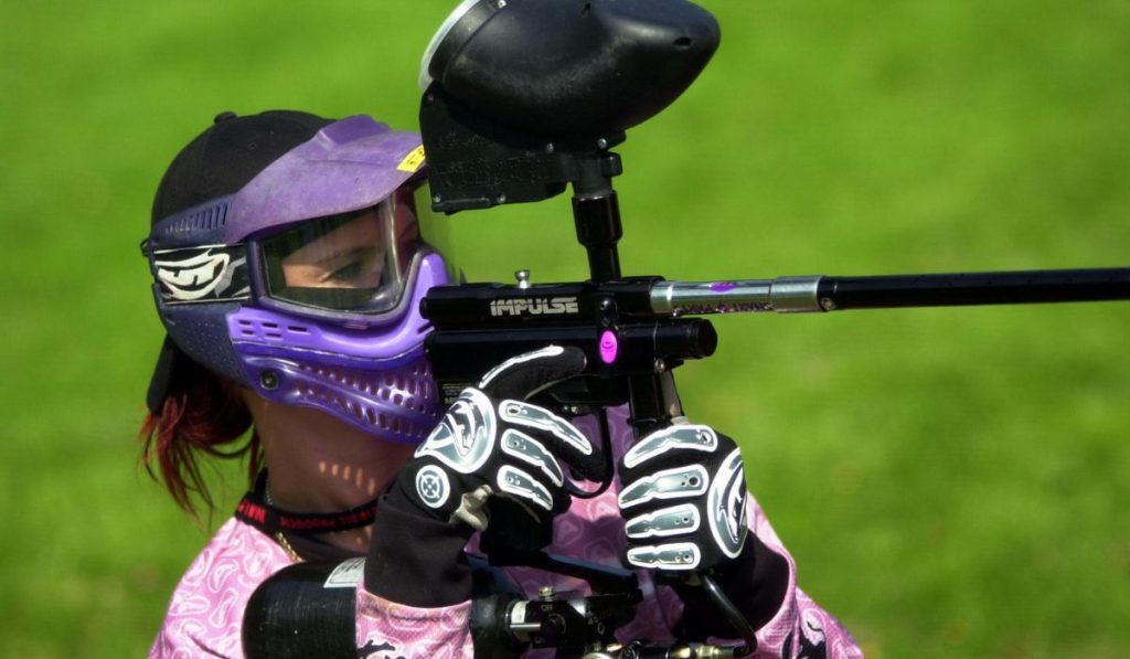 girl playing paintball during tournament
